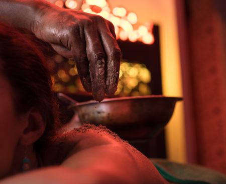 Woman having oil ayurveda spa treatment, close-up of the hands of therapistの写真素材