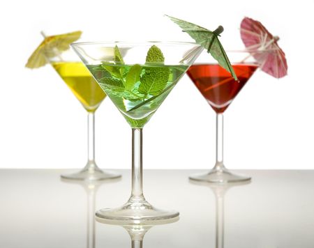 three cocktails with umbrella isolated on whiteの写真素材