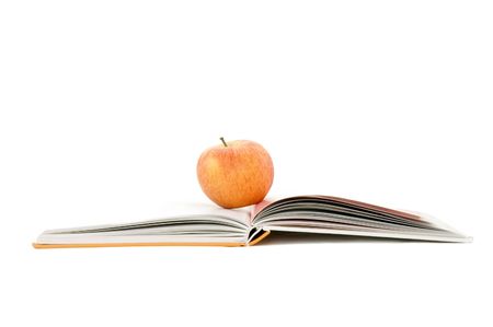 apple and book isolated on whiteの写真素材