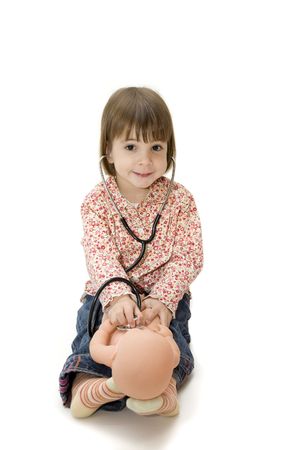 little girl playing with a stethoscopeの写真素材