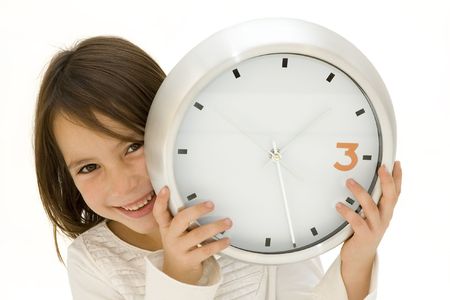 little girl behind a clock isolated on white