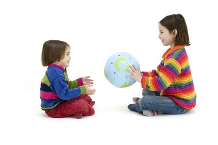two children embracing the world globe isolated on whiteの写真素材