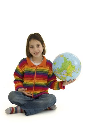 young girl holding the world globe isolated on whiteの写真素材