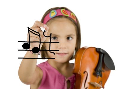 little girl holding a pen and a violin isolated on whiteの写真素材
