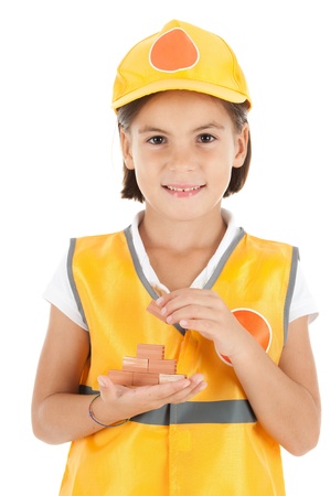 little girl building a wall isolates on white background の写真素材