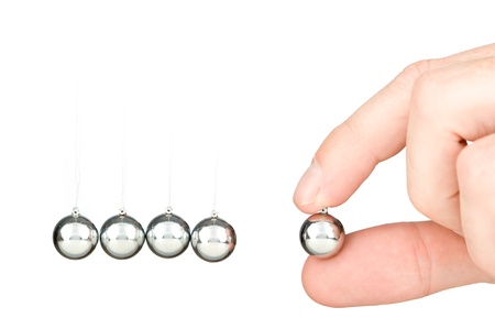hand holding a pendulum ball 
