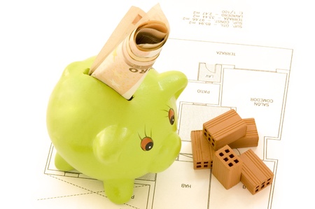 piggy bank with money and bricks の写真素材