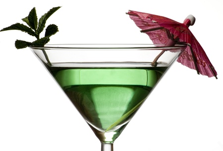 green cocktail with umbrella isolated on white backgroundの写真素材
