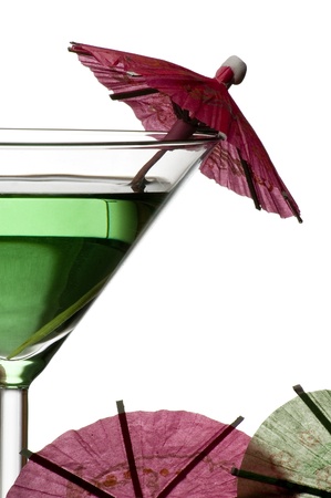 green cocktail with umbrellas isolated on white background の写真素材