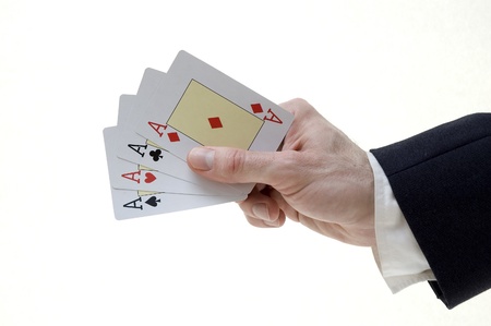 businessman holding four aces 