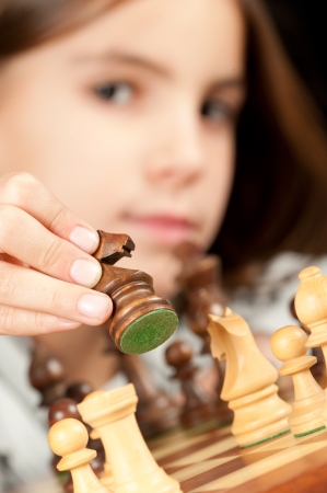little girl playing chessの写真素材