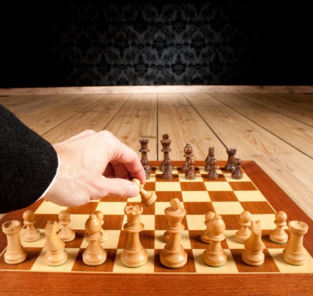 businessman hand holding a pawn from a chessboardの写真素材