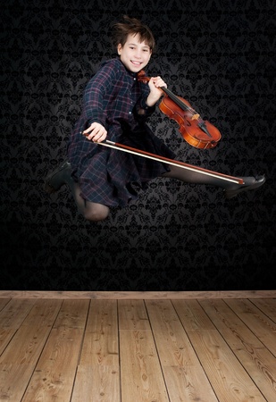 girl with violin jumpingの写真素材