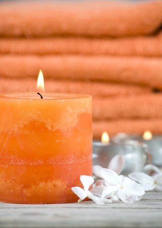 orange towels with candle on woodenの写真素材