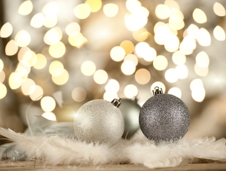 silver christmas balls on a blurred lights backgroundの写真素材