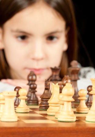 little girl playing chessの写真素材