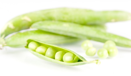 pods of green peas on white backgroundの写真素材