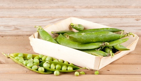 pods of green peas on wood backgroundの写真素材