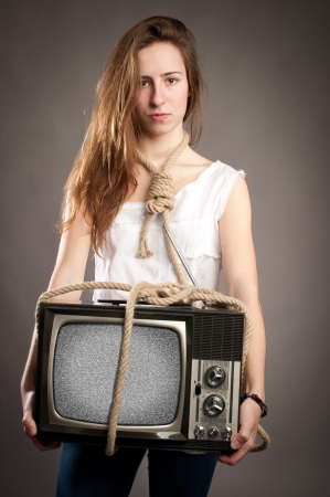 young girl with rope holding retro televisionの写真素材