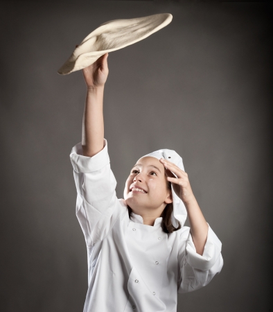 young chef working the dough for pizzaの写真素材