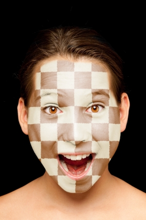 portrait of girl with chessboard painted on her faceの写真素材