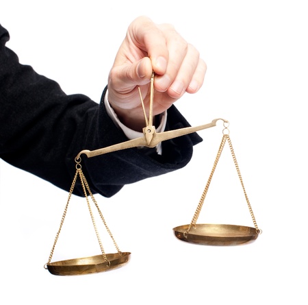 businessman hand holding a balance on white backgroundの写真素材