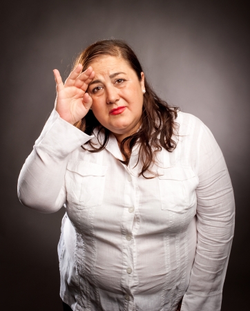 woman with headache holding headの写真素材