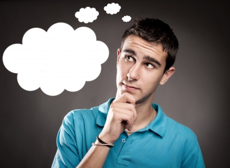 young man thinking with a cloud over his headの写真素材