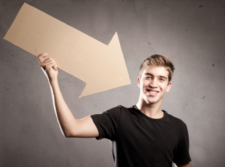 young man pointing to himself with an  arrow cardboardの写真素材
