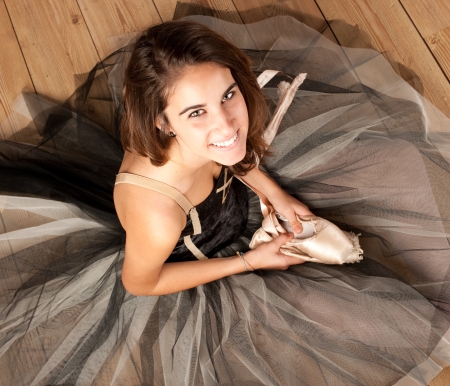 attractive ballerina holding ballet shoesの写真素材