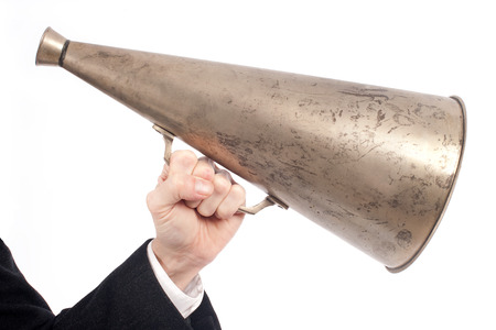 businessman hand holding an old megaphone isolated on white 