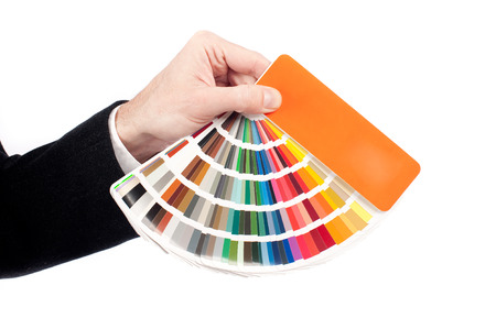 businessman hand holding a pantone palette isoalted on white 