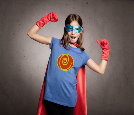 little girl wearing a superhero costumeの写真素材