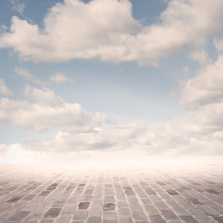 cobblestone background with sky on sunsetの写真素材