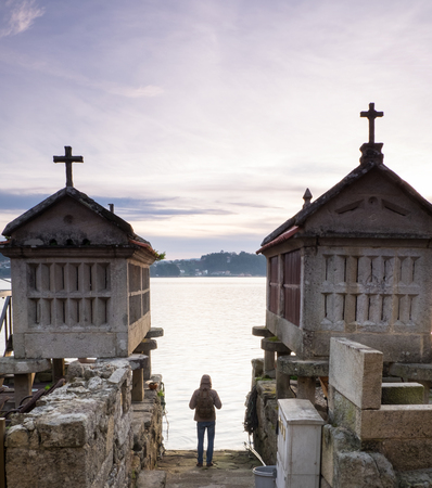 tourist walking in the town of Combarro, Pontevedra, Galicia, Spain