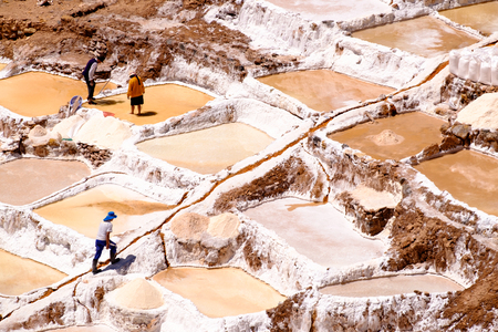 people working collecting salt from the Maras salines, Urubamba Valley, Peru, 2016, august, 28のeditorial素材