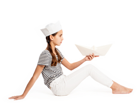 little marine holding a paper boat on a white backgroundの写真素材