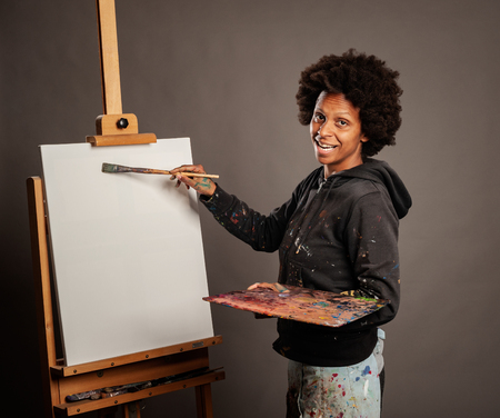 black woman painting on a gray backgroundの写真素材