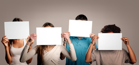 group of people holding an empty banner on a gray backgroundの写真素材