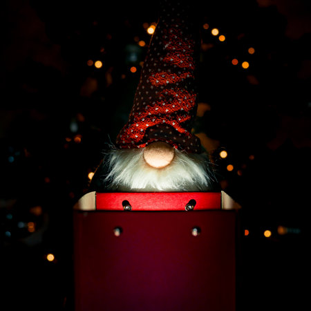 Christmas photo of Santa Claus, Santa Claus, with Christmas tree and lights, looking for his gift in a red box with interior light. surpriseの写真素材