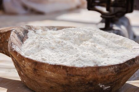 Wheat flour in a wooden dish in selective focusの写真素材