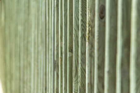 A green colored wooden fence in selective focusの写真素材