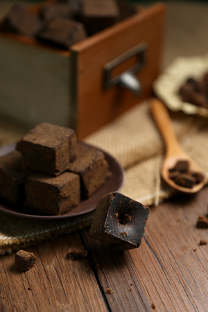 Brown sugar chunks in wooden boxes and platesの写真素材