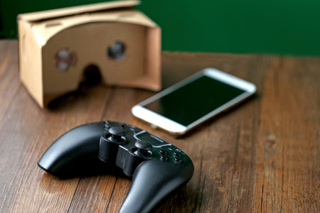 Virtual reality glasses on the table, games consoles and smart phones