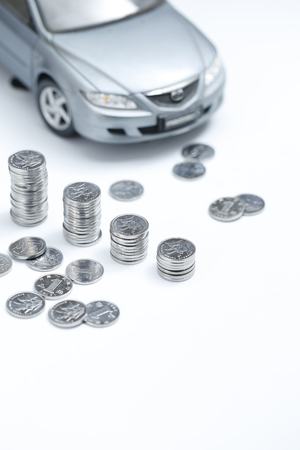 coin stacks in front of carの写真素材