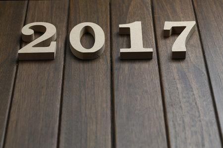 2017 happy new year, wooden numbers on retro wooden desk