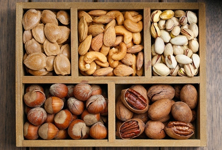 Various nuts in wooden boxの写真素材