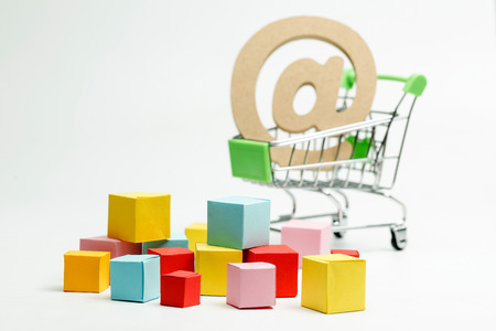 wooden symbol of at sign in shopping cart, Online shopping conceptの写真素材