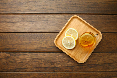 lemon black tea in glass cup on wooden table の写真素材