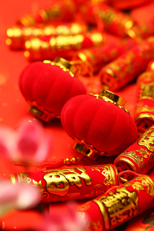 Chinese new year lanterns and fake firecrackers on red background that says good luck and happinessの写真素材